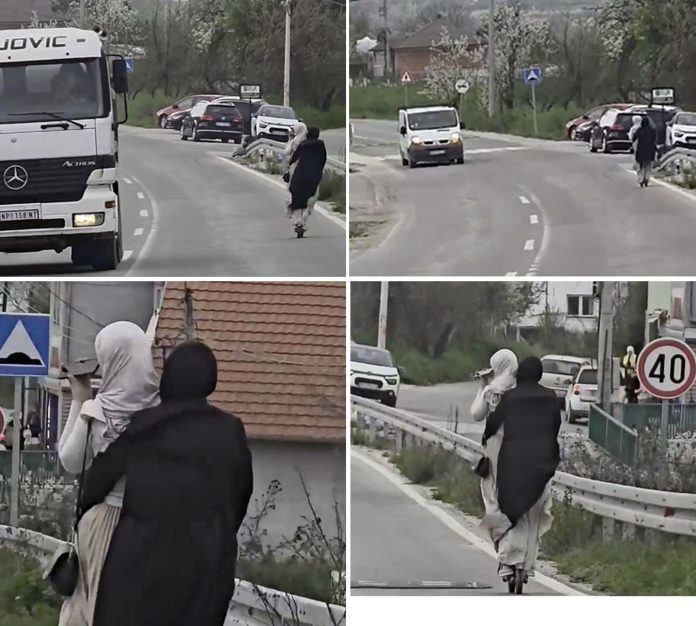 Električni trotinet na magistralnom putu u Novom Pazaru, uz mobilni telefon u toku vožnje